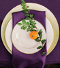 Purple textured linen with white plate and purple napkin.