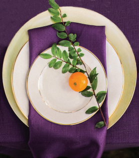 Purple textured linen with white plate and purple napkin.